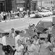 Black parents and children stand across the street as white women and children protest school integration in Baltimore, Maryland. September 30, 1954. Image via AP.